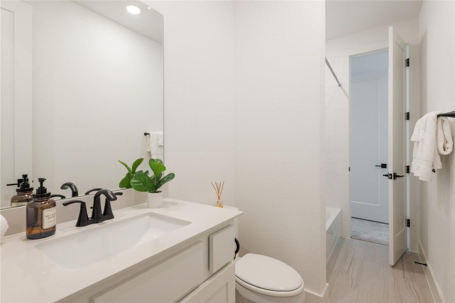 A well-lit, contemporary bathroom boasts elegant fixtures and clean-lined design. A well-lit, contemporary bathroom boasts elegant fixtures and clean-lined design.