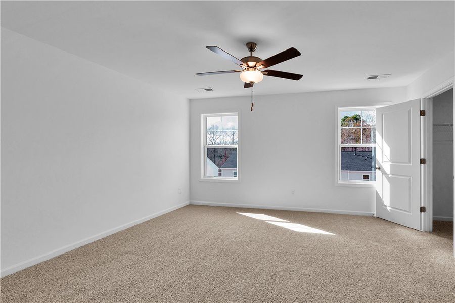 This spacious bedroom offers ample natural light a