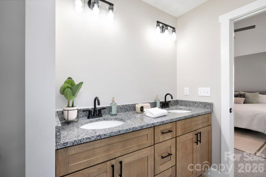 Dual Vanity with Granite Countertop and Woodgrain Cabinets