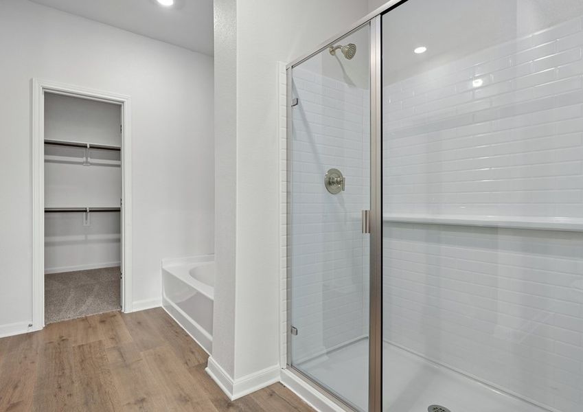 The master bathroom has a large garden tub and a glass, walk-in shower. The master bathroom has a large garden tub and a glass, walk-in shower.