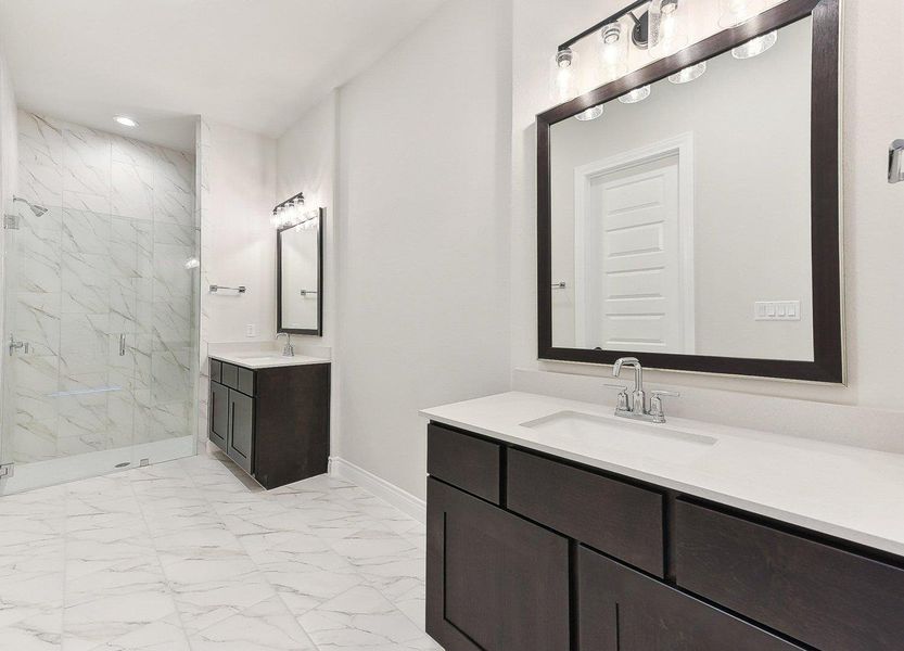 Bathroom with baseboards, marble finish floor, a sink, and a marble finish shower