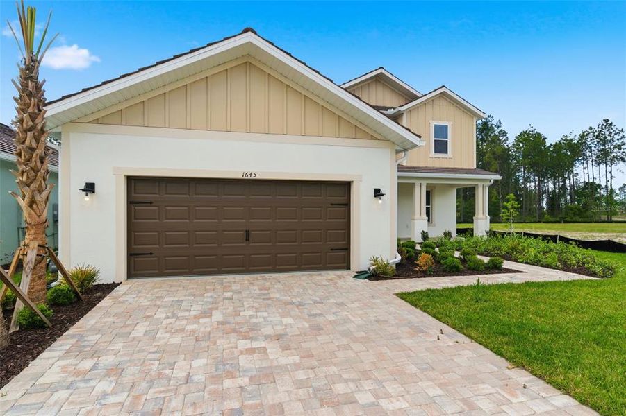 Front exterior of a new home in Hammock at Two Rivers, Zephyrhills, FL, highlighting curb appeal (Image 27).