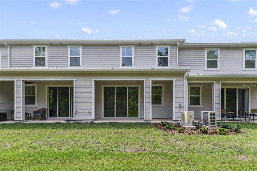 Front exterior of a new home in Towns at Greenleaf, Oviedo, FL, highlighting curb appeal (Image 1).