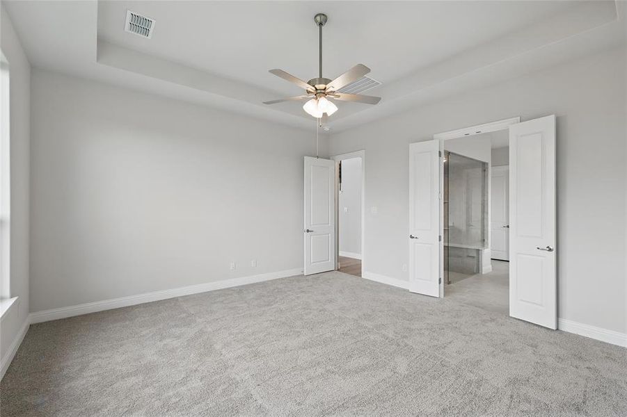 Unfurnished bedroom with carpet, baseboards, and ceiling fan