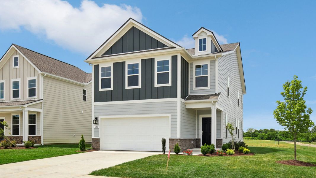 Home exterior with two tone blue siding and 2-car garage