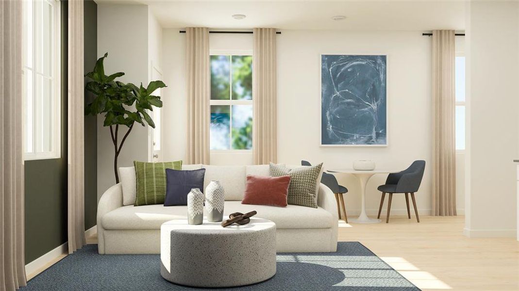 Living area with baseboards and wood finished floors