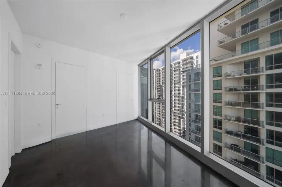 Floor-to-ceiling glass windows, polished concrete flooring, and flush-mount interior doors Floor-to-ceiling glass windows, polished concrete flooring, and flush-mount interior doors