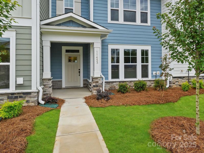 Front exterior of a new home in North Creek Village - Townhomes, Huntersville, NC, highlighting curb appeal (Image 21). Front exterior of a new home in North Creek Village - Townhomes, Huntersville, NC, highlighting curb appeal (Image 21).