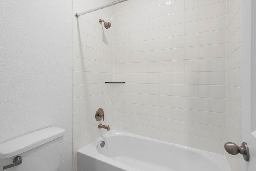 The secondary bath features tile flooring, white cabinetry and light countertops and a shower/tub combo. Perfect for accommodating any visiting family and friends. The secondary bath features tile flooring, white cabinetry and light countertops and a shower/tub combo. Perfect for accommodating any visiting family and friends.