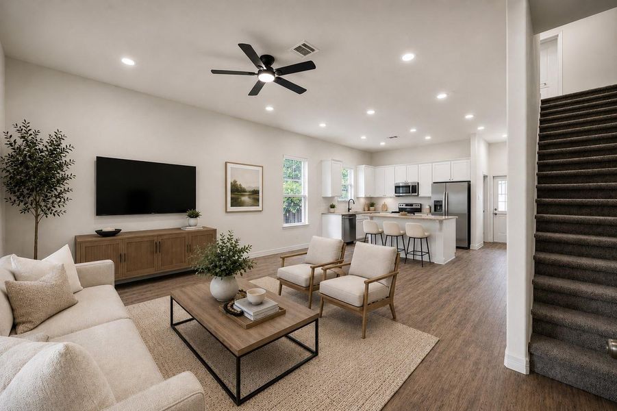 Experience modern elegance in this virtually staged open-concept living space, featuring a sleek kitchen, cozy seating area, and stylish finishes that invite you to envision your dream home.