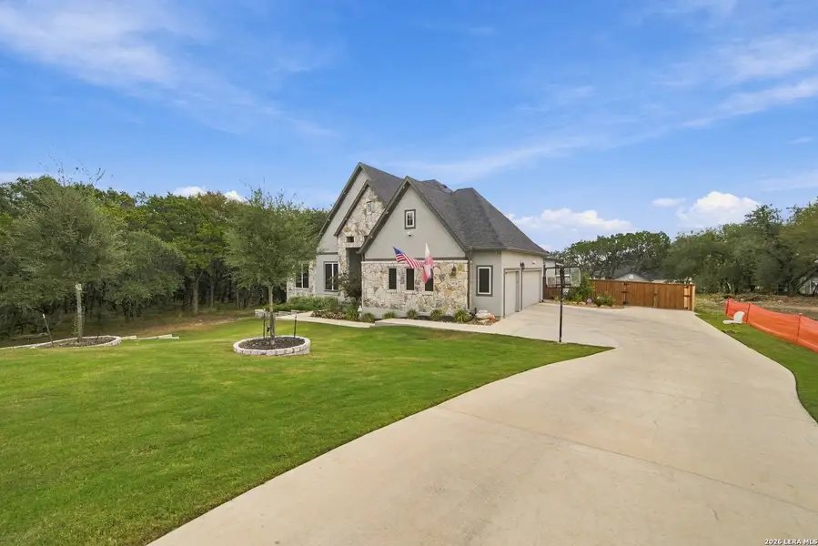 Front exterior of a new home in Heimer Estates at Garden Ridge, San Antonio, TX, highlighting curb appeal (Image 18).