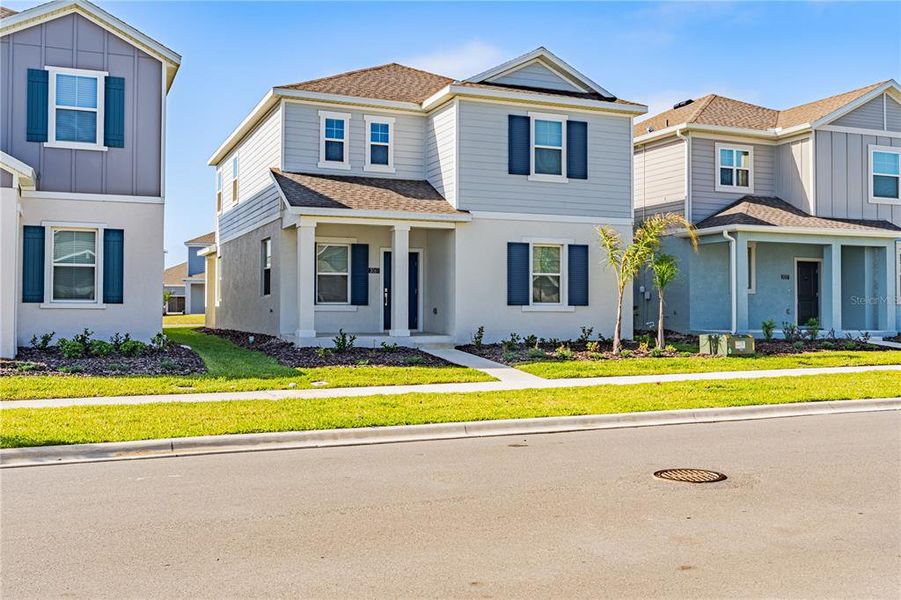 Front exterior of a new home in Wellness Ridge, Clermont, FL, highlighting curb appeal (Image 27).