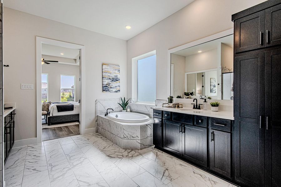 Spa-inspired primary bath with a freestanding soaking tub and separate shower