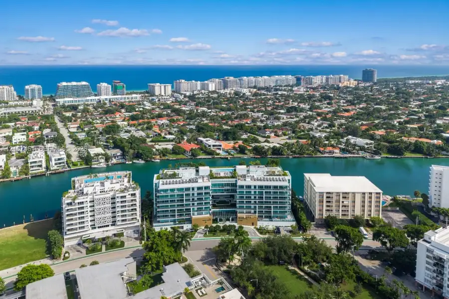 Aerial perspective of a multi-story waterfront residential building featuring floor-to-ceiling glass paneling, private balcony terraces, and rooftop amenities Aerial perspective of a multi-story waterfront residential building featuring floor-to-ceiling glass paneling, private balcony terraces, and rooftop amenities