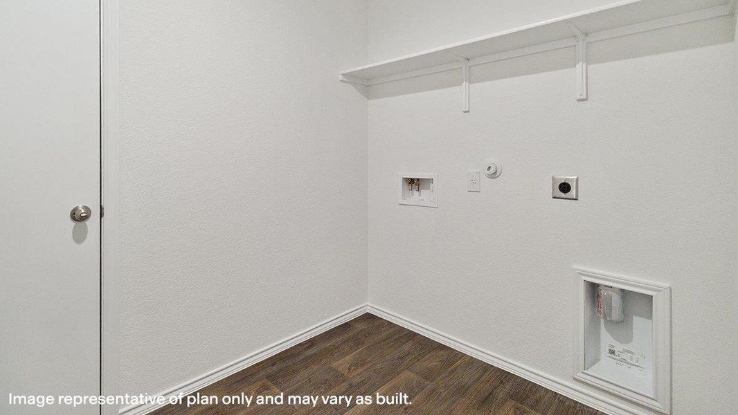 A dedicated laundry room with hookups and convenient shelving provides a functional space. A dedicated laundry room with hookups and convenient shelving provides a functional space.