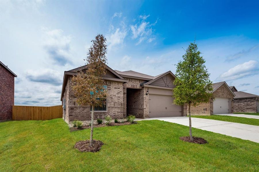 View of front of house featuring a front lawn and a garage