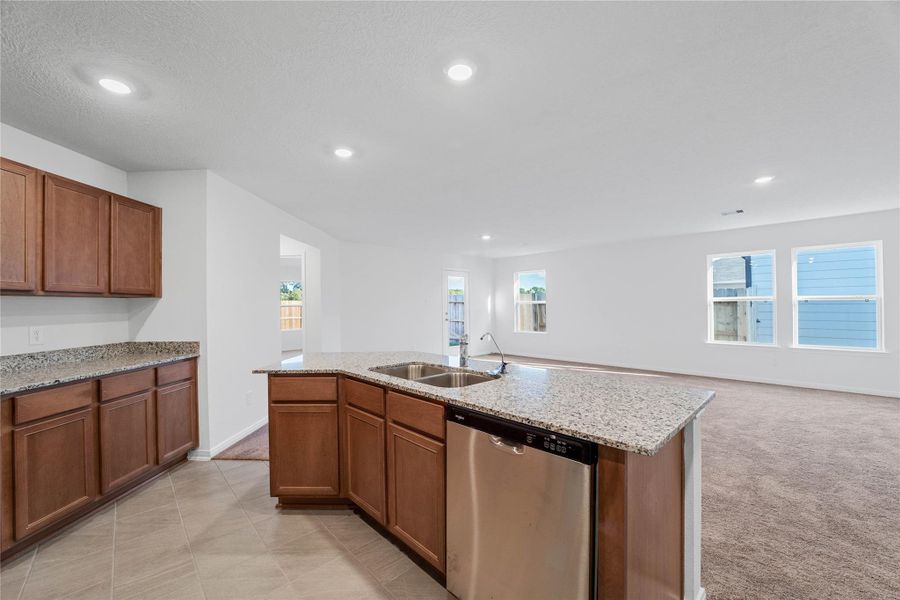 Additional view from the kitchen showcasing the kitchen island and the view into the Great Room. Additional view from the kitchen showcasing the kitchen island and the view into the Great Room.