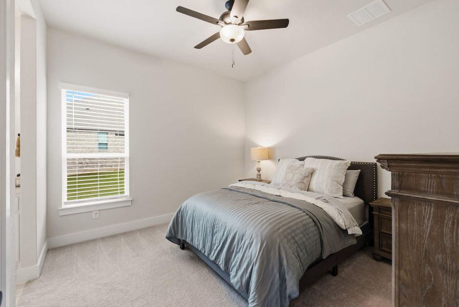 The second guest bedroom is bright and spacious, connecting directly to a shared bathroom layout that maximizes privacy while keeping the room feeling open