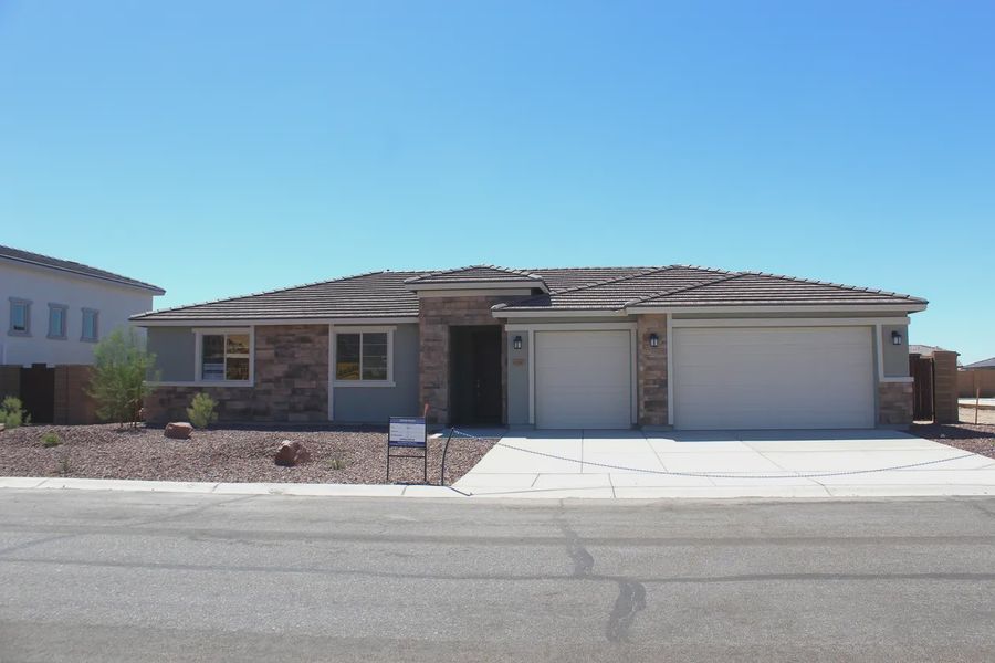 Front exterior of a new home in Las Barrancas, Yuma, AZ, highlighting curb appeal (Image 1). Front exterior of a new home in Las Barrancas, Yuma, AZ, highlighting curb appeal (Image 1).
