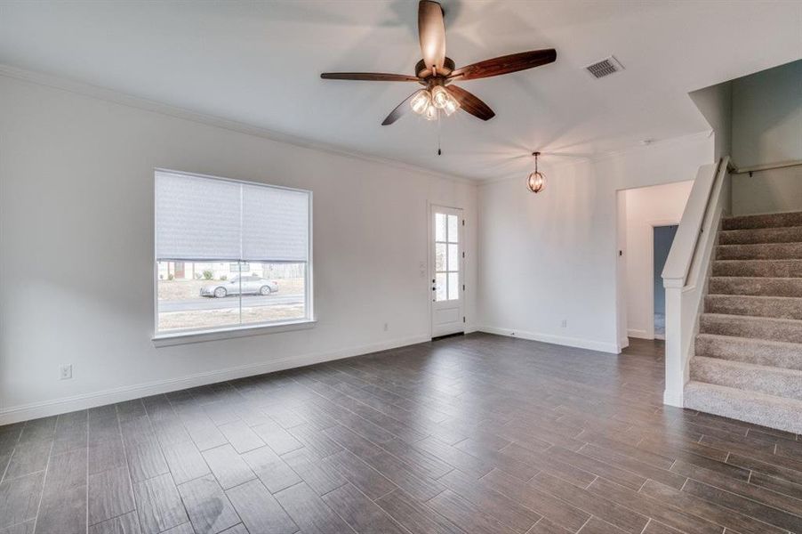 Spare room with ceiling fan and crown molding