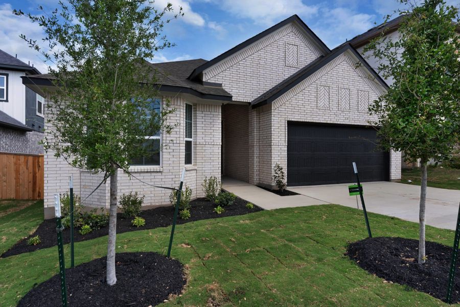 Front exterior of a new home in University Heights, Round Rock, TX, highlighting curb appeal (Image 27).