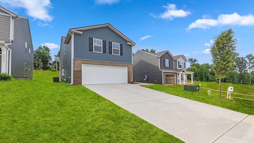 Front exterior of a new home in Paddock Point, Roebuck, SC, highlighting curb appeal (Image 19).