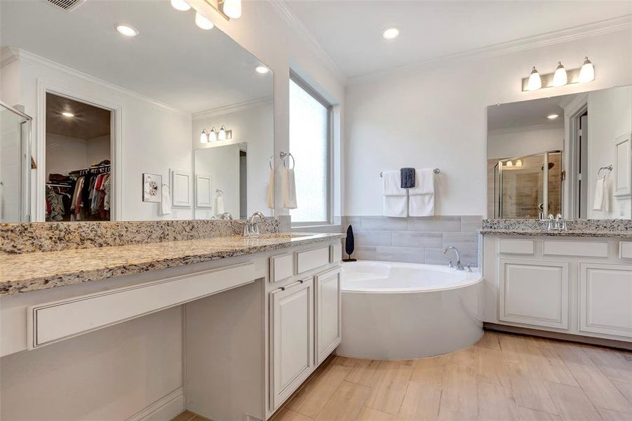 Primary bath complete with separate shower, double vanity, big soaking tub and huge walk in closet.