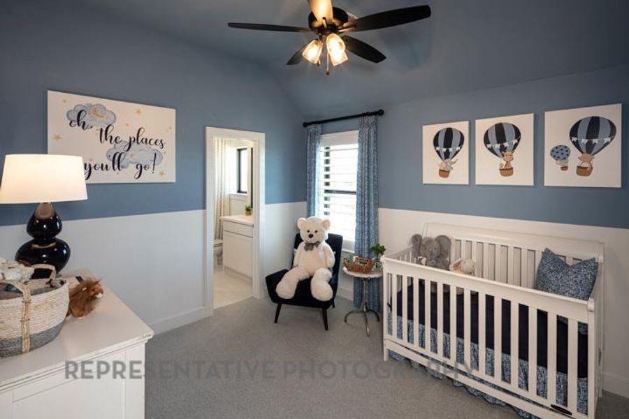 Carpeted bedroom with lofted ceiling, ceiling fan, and ensuite bathroom Carpeted bedroom with lofted ceiling, ceiling fan, and ensuite bathroom
