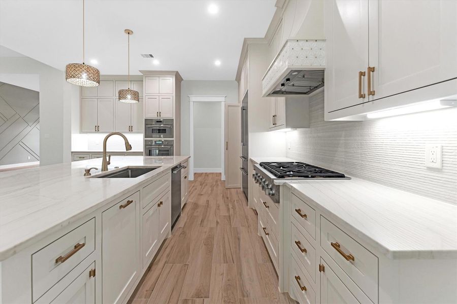 This kitchen includes stainless steel appliances, a gas cooktop, and ample storage.