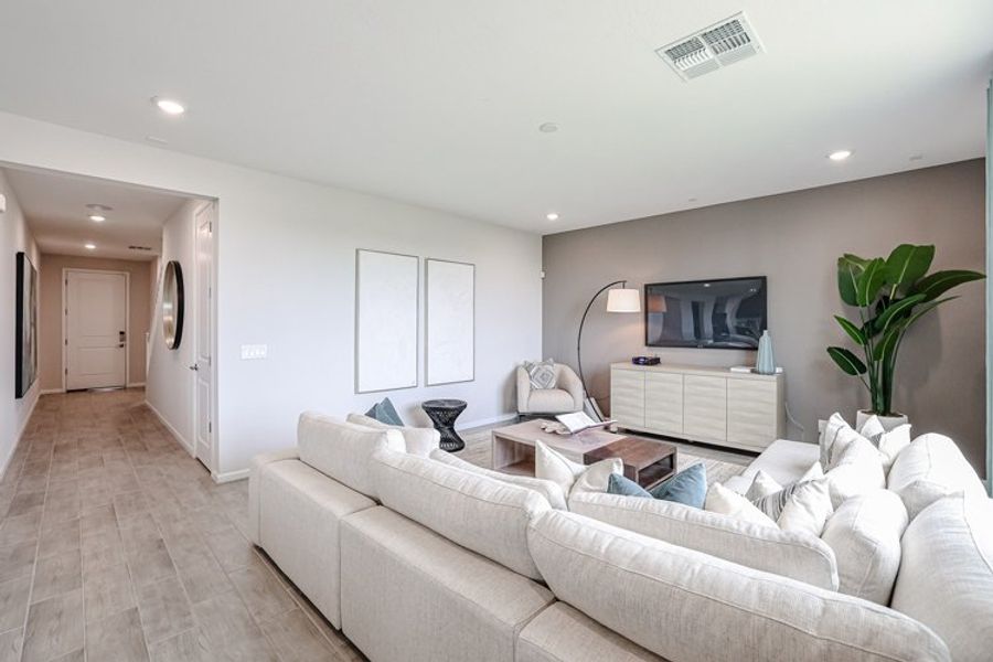 A living room with a white couch. A living room with a white couch.