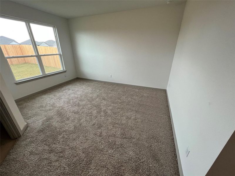 Carpeted empty room featuring baseboards Carpeted empty room featuring baseboards