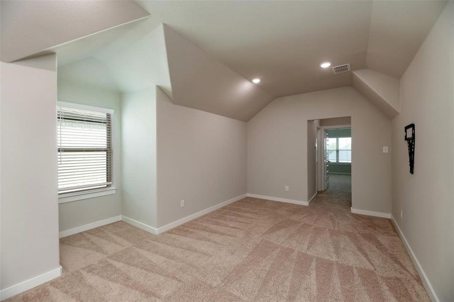 Bonus room with lofted ceiling, light carpet, and recessed lighting Bonus room with lofted ceiling, light carpet, and recessed lighting
