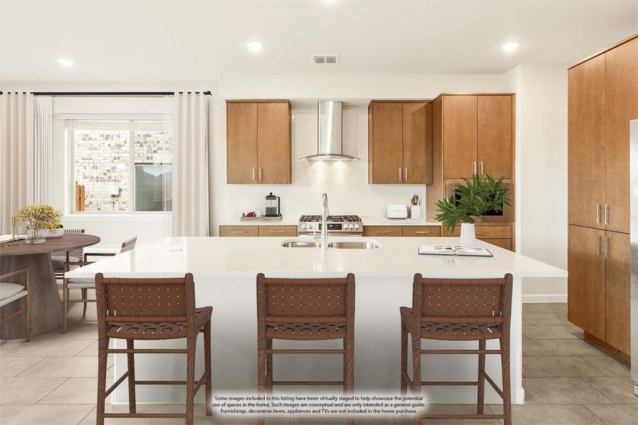 Kitchen with large white island, three bar stools, wood cabinets, and stainless steel range hood Kitchen with large white island, three bar stools, wood cabinets, and stainless steel range hood