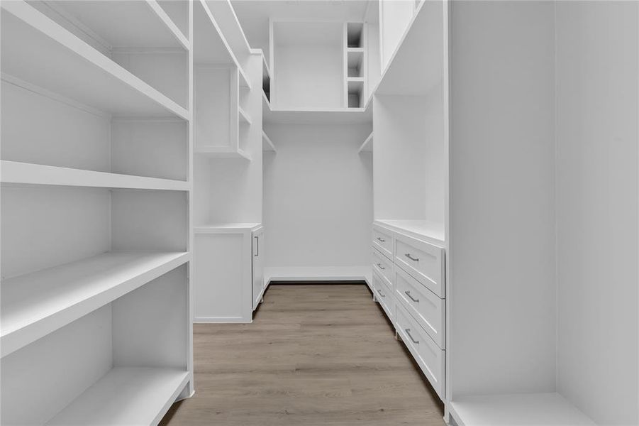 Primary walk-in closet with built-ins