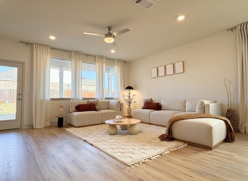Living room featuring wood finished floors, a ceiling fan, and recessed lighting