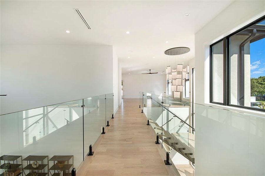 Hallway with recessed lighting and light wood-style flooring