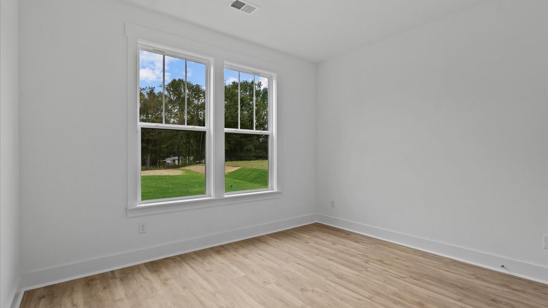 Desirable hardwood flooring in all bedrooms creates a cohesive and elegant interior