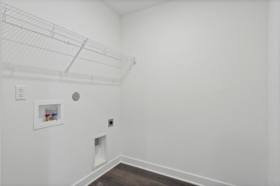 Laundry area with wood-finish flooring and a white wire shelf