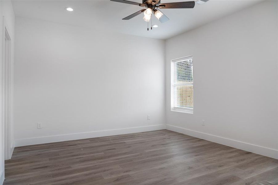 Spare room with hardwood / wood-style flooring and ceiling fan