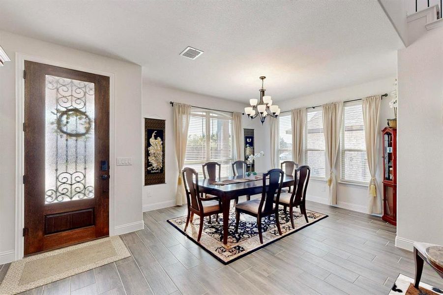 Dining room featuring a chandelier and light wood-type flooring