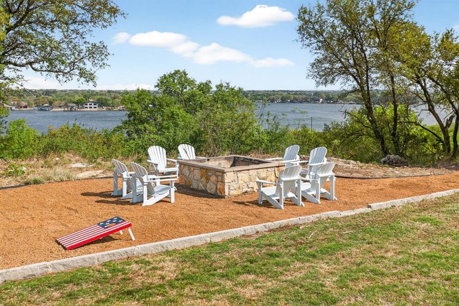 Step down the hill from the pool to the fire pit and game area.