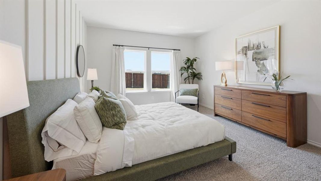 Bedroom featuring light carpet and baseboards Bedroom featuring light carpet and baseboards