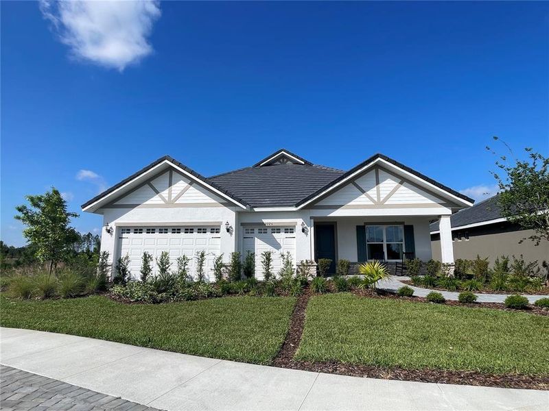 Front exterior of a new home in Tamarack at Two Rivers, Zephyrhills, FL, highlighting curb appeal (Image 1). Front exterior of a new home in Tamarack at Two Rivers, Zephyrhills, FL, highlighting curb appeal (Image 1).