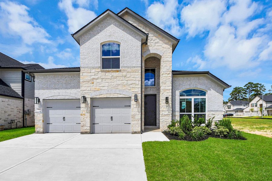 This home boasts lush green grass and meticulous landscaping. Its premium elevation showcases an exquisite blend of brick and stone features, complemented by modern coach lighting.