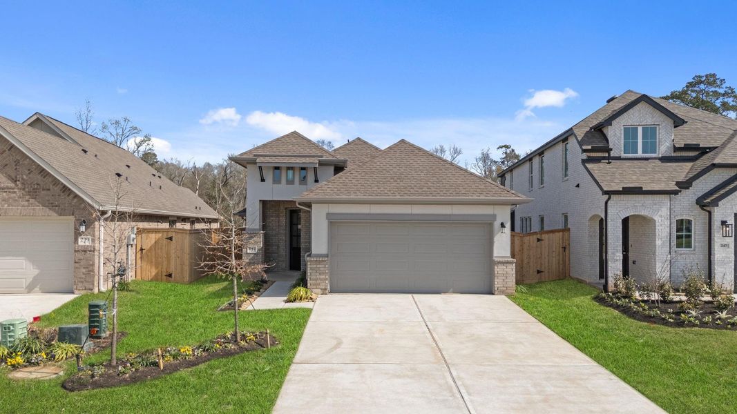 Front exterior of a new home in Grand Central Park, Conroe, TX, highlighting curb appeal (Image 1). Front exterior of a new home in Grand Central Park, Conroe, TX, highlighting curb appeal (Image 1).