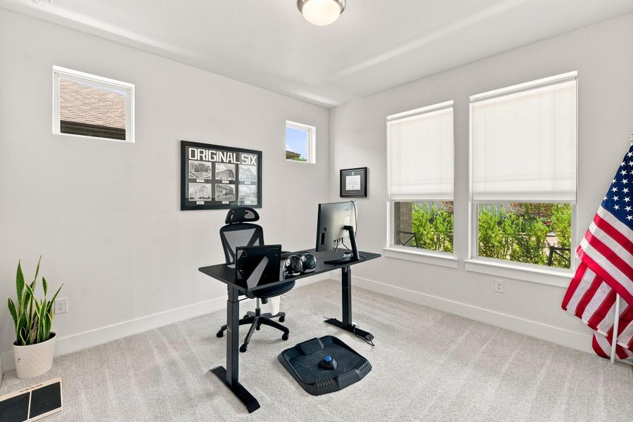 Main-floor bedroom conversion at the front of the home with plush carpeting and large windows, perfect for a quiet home office or guest suite. Main-floor bedroom conversion at the front of the home with plush carpeting and large windows, perfect for a quiet home office or guest suite.
