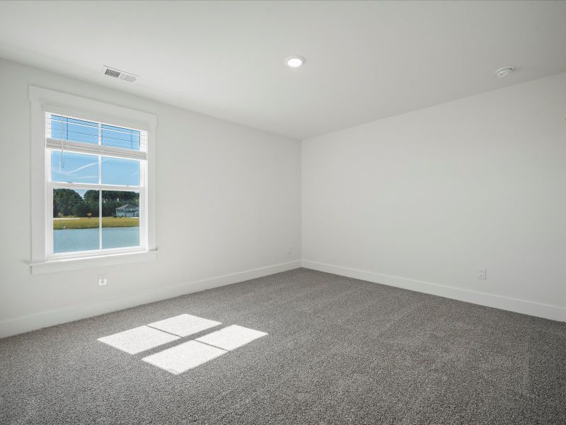 Spacious, unfurnished interior of a new home in The Coves at Lakes of Cane Bay II, Summerville (Image 28).