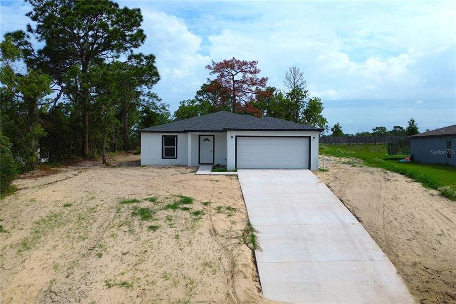 Front exterior of a new home in , Spring Hill, FL, highlighting curb appeal (Image 23).
