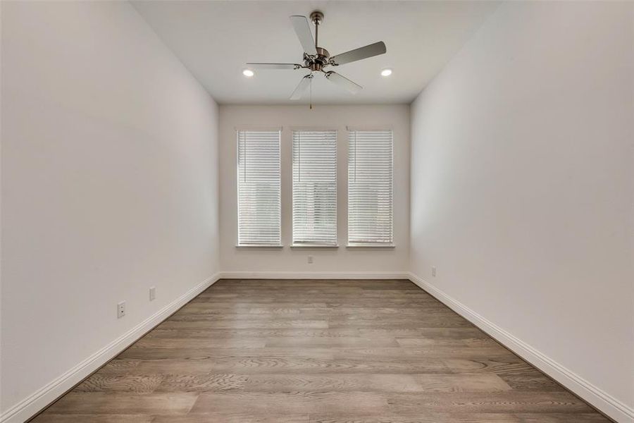 Unfurnished room with light wood-type flooring and ceiling fan