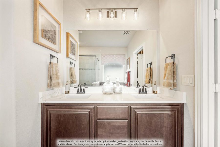 Bathroom with double sink vanity, dark wood cabinets, white countertop, large mirror, and overhead light bar Bathroom with double sink vanity, dark wood cabinets, white countertop, large mirror, and overhead light bar